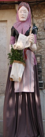 Rosa, the Selva giantess with her bag for colleting herbs and a book relating her story